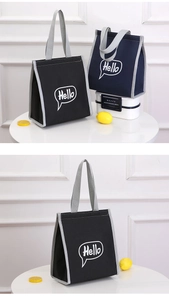 Macro shot of durable oxford fabric insulated lunch bag with comfortable grey handles
