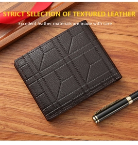 Detail view of deep brown leather wallet with geometric embossing on a wooden desk