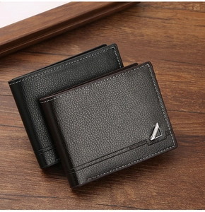 Detailed view of men's bifold wallets in black and coffee leather on wood surface