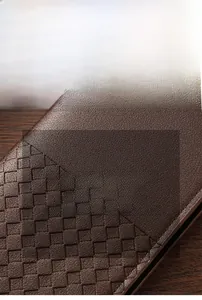 Detail of premium brown leather wallet showing woven texture and scratch resistant surface