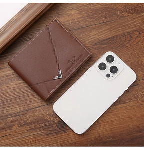 Brown leather wallet detail with contrast stitching and vintage metal corner ornament