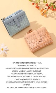 Detail of short crocodile embossed women's wallet showing card slots and zipper pocket
