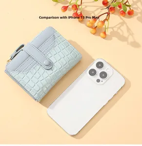 Size comparison of light blue crocodile texture wallet with an iPhone 13 Pro Max