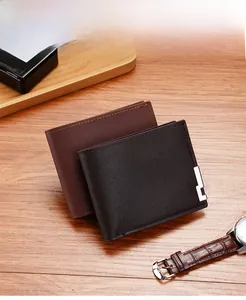 Close-up of leather men's wallets with lychee texture and metal edge on wood desk