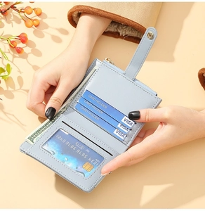 Light blue faux leather card holder wallet showing card slots and zipper pocket detail