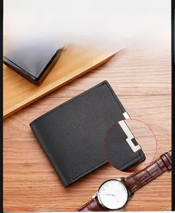 Close-up of black litchi grain leather men's wallet with L-shaped metal edge detail
