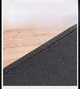 Detailed macro of black lychee grain leather wallet with oil edge finish and stitching