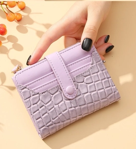 Close-up of lavender faux crocodile leather mini wallet with multiple card slots and zipper