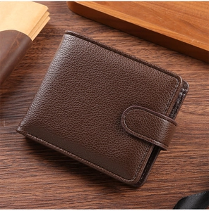 Close-up of vintage dark brown PU leather wallet with lychee texture and snap fastener