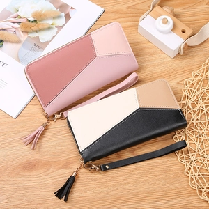 Women's long zipper wallets featuring patchwork design with tassel and wristlet