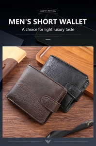 Close-up of men's short leather wallets with lychee texture and snap fastener on wood