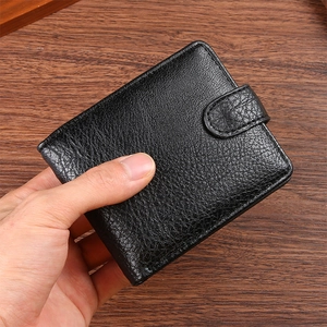 Close-up of black men's short leather wallet with litchi texture and snap button closure
