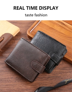 Close-up of litchi texture brown and black men's wallets on wooden background