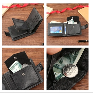 Detail view of black faux leather bifold wallet with card slots and coin pocket on wood