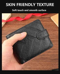 Macro detail of men's black leather wallet showing litchi texture and hand-held soft feel
