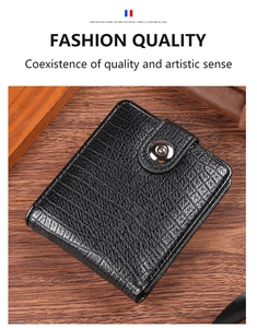 Close-up of black crocodile embossed leather men's wallet with metal snap closure on wood
