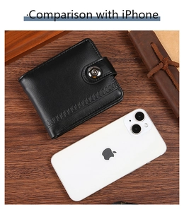 Size comparison of a black PU leather wallet next to an iPhone on a wooden desk