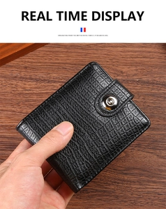 Close-up of black crocodile pattern embossed leather wallet with metal snap closure