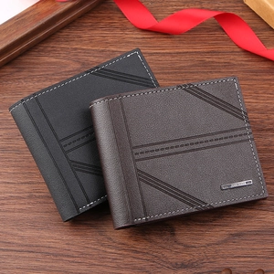 Close-up of men's short wallets in black and dark brown leather with diagonal texture