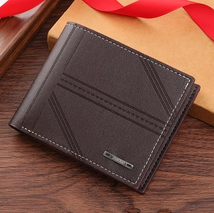 Detail of dark brown leather wallet with geometric embossing and white stitching