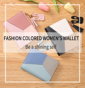 Close-up of stylish tricolor patchwork wallets with fringe tassels and cute rabbit charms