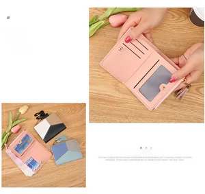 Detail of short leather wallet with tassel zipper, rabbit charm and multiple card slots