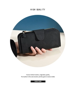 Close-up of black frosted long wallet with gold zipper, buckle and hand strap detail