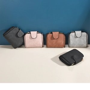 Close-up of five compact matte leather wallets in gray pink coffee and black colors