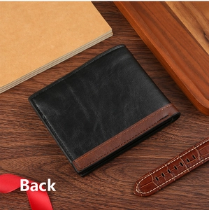 Detailed back view of a men's bifold leather wallet on a rustic dark wooden desk
