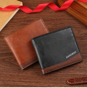 Close-up of dual-style matte leather wallets showing stitching on a wooden surface