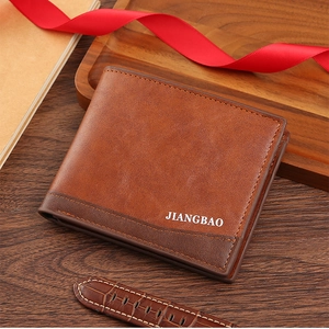 Detail of bifold brown leather wallet with contrast stitching on dark wood background