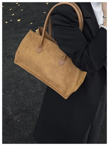 Close-up of caramel brown matte tote bag with corduroy texture and sturdy handles