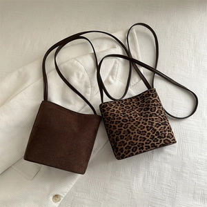 Minimalist bucket shoulder bags in dark brown suede and stylish leopard print patterns