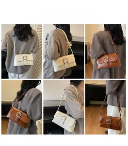 Detail of vintage baguette bag with oil wax leather texture and silver buckle accents