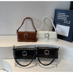 Detailed display of vintage baguette bags in brown, white, and black with silver buckles