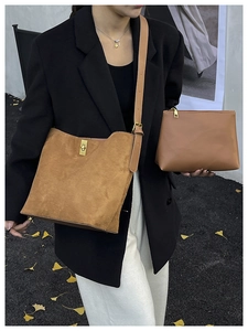 Brown faux suede tote bag set styled with casual outfit among autumn leaves