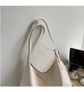 Detailed view of the soft off-white leather tote bag featuring a comfortable handle design