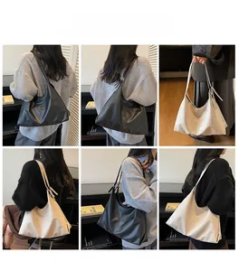 Minimalist large tote bag shown in black and beige on models in a cozy library setting