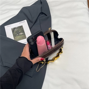 Braune Abendtasche mit goldenem Wellengriff und Kette, offene Ansicht mit Stauraum