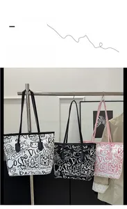 Detail view of large graffiti print tote bags with Coca-Cola logo for daily commute