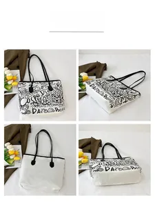 Multi-angle views of a canvas tote bag featuring black graffiti cats and doodles