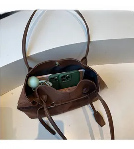 Detail view of brown large capacity tote bag with magnetic closure and spacious interior
