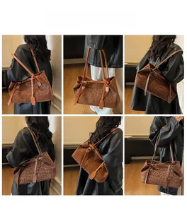 Macro detail of large leopard print tote bag with brown leather straps and side buckles