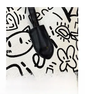 Detail of the stitching and doodle canvas texture on this graffiti shoulder tote bag