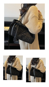 Detail of black leopard print tote bag with plush texture and stylish side ties