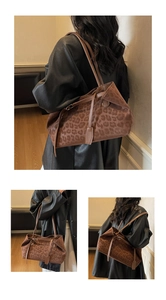 Detail of leopard print tote bag showing suede texture and leather shoulder straps