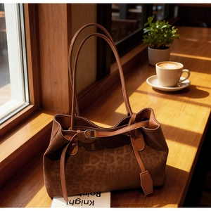 Detailed view of leopard print tote bag texture with elegant leather strap and buckle