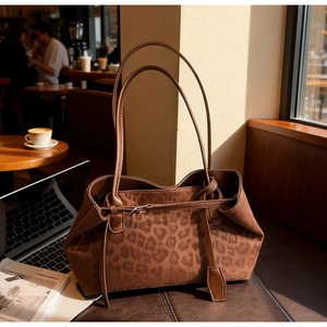 Detailed close-up of brown leopard print tote bag in soft suede with leather straps