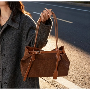 Detail of leopard print tote bag featuring leather strap and buckle on grey wool coat