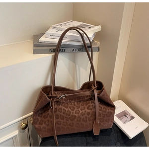 Close-up of leopard print tote bag with matte texture and dual slender shoulder straps